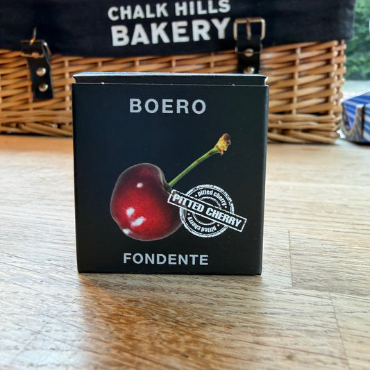 Boero coffee packaging with a cherry illustration on a wooden surface, with 'Chalk Hills Bakery' in the background.