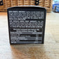 Back of a dark chocolate covered cherry packaging with ingredient list and nutritional information on a wooden surface.
