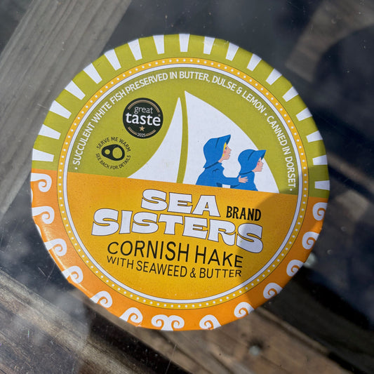 Sea Sisters Cornish Hake with Seaweed & Butter packaging on a glass surface
