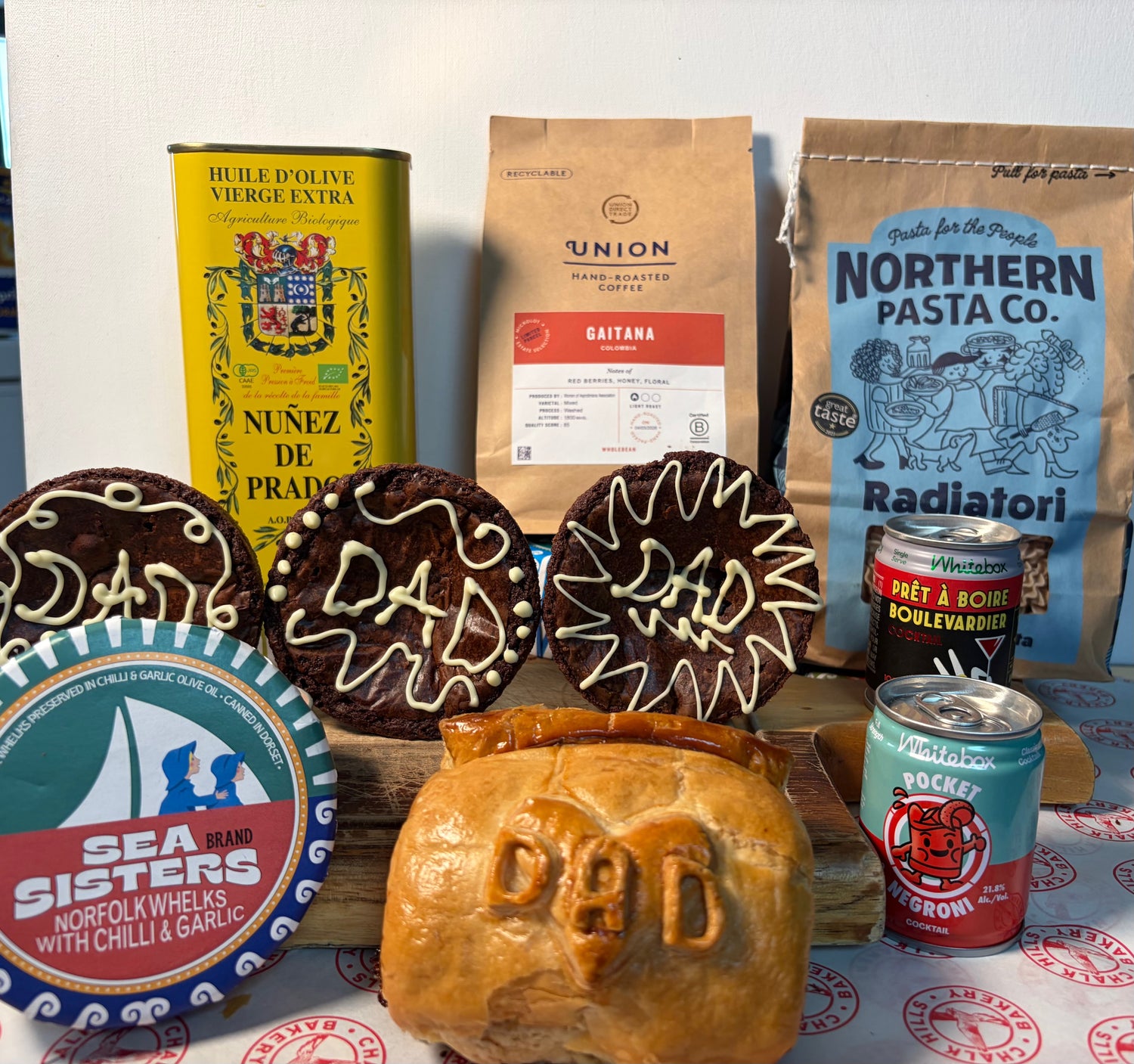 Collection of Father's Day themed items including cookies, bread, and packaged goods on a table.