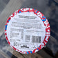Label of whole cornish sardines with Tunisian harissa on a glass surface