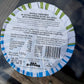 Back of a sardine can label with text and barcode on a glass surface