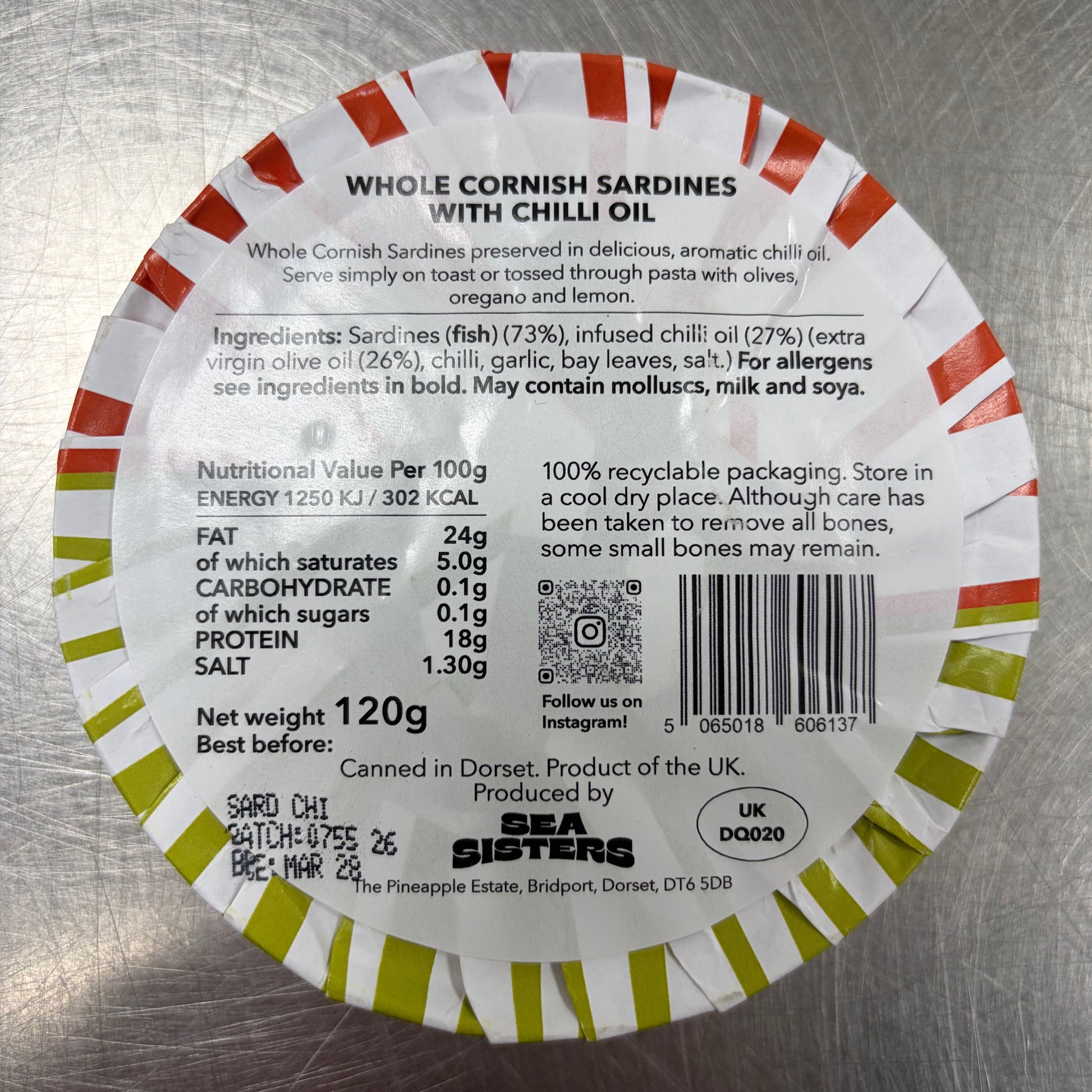 Round label with text and nutritional information on a metallic surface