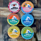 Collection of Sea Sisters brand tins on a glass and wooden surface