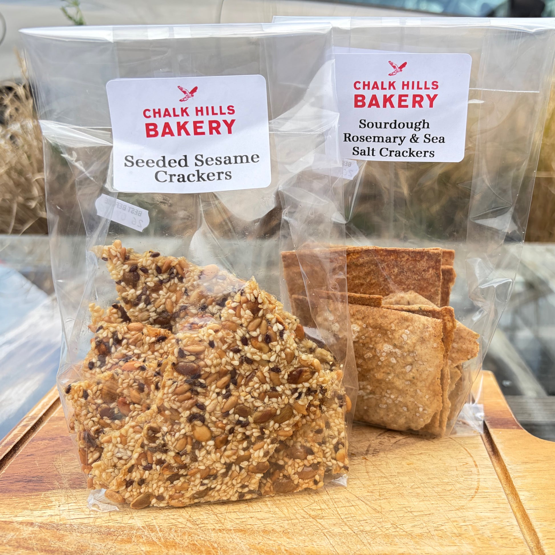 Two packages of Chalk Hills Bakery crackers on a wooden surface