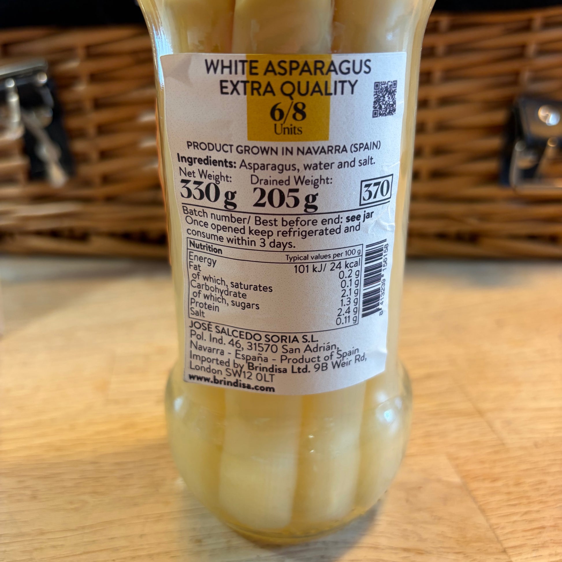 Bottle of white asparagus with a label on a wooden surface